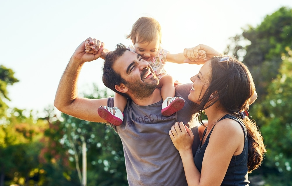 Family,,Dad,And,Daughter,On,Shoulders,In,Park,With,Mom, 1766171902 shutterstock 2305309561 3 1