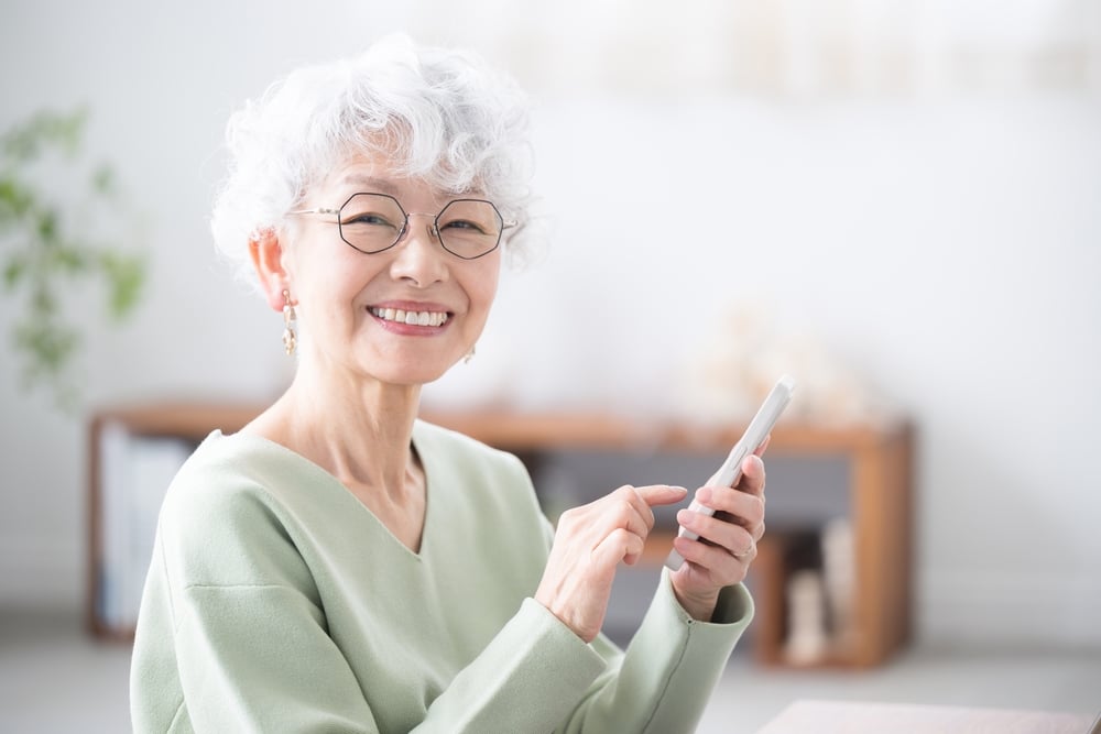Smiling,Senior,Woman,Holding,A,Smart,Phone,(smartphone),,Looking,At 1766172027 shutterstock 2479820769 1