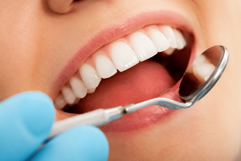 Close-up of a patient having their dental fillings examined at a routine dental exam.